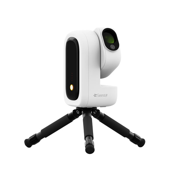 A white and black SeeStar S50 Pro on a small black tripod base, shown against a solid white background. The camera features a sleek white body with black accents, including a large black vertical panel on the side and a circular lens area on the top right. | Seestar S50 PRO Smart Telescope
